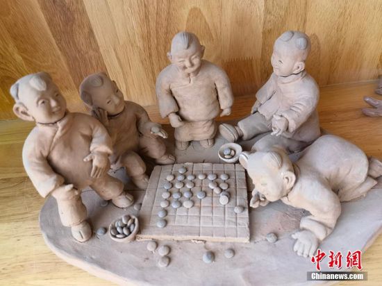 圖為泥塑作品展現(xiàn)下棋場景。 劉玉桃 攝