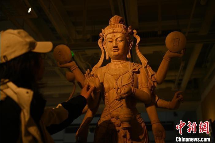 圖為季茂杰觀(guān)察自己創(chuàng)作的敦煌木雕。李亞龍 攝</p>
<p>