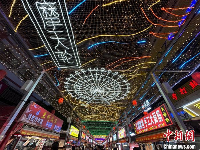 圖為明清街夜市燈光點(diǎn)亮具有武威文化元素的“摩天輪”彩燈?！〈魑牟?攝</p><p>